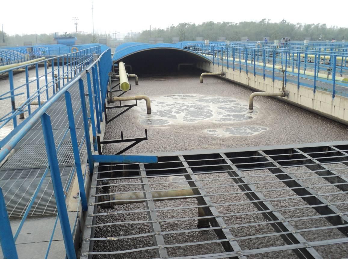 What are the hazards of not disposing of hazardous waste sludge in a timely manner?